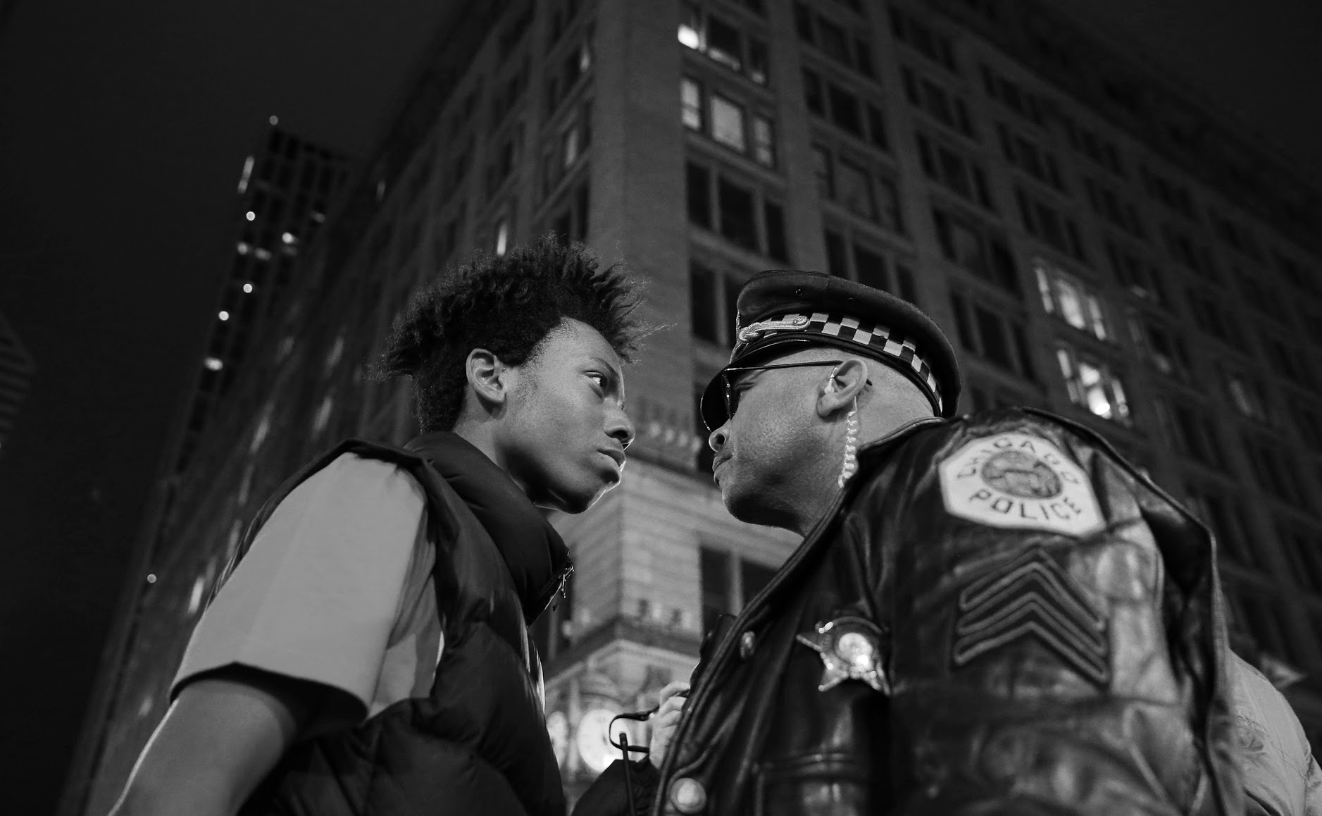 Lamon Reccord, left, scolds a police sergeant during a police violence protest and march at State and Randolph streets Wednesday, Nov. 25, 2015, in Chicago.(John J. Kim/Chicago Tribune)