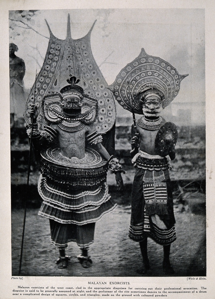 V0015993 Two Malayan exorcists dressed in elaborate ritual costume. H Credit: Wellcome Library, London. Wellcome Images images@wellcome.ac.uk http://wellcomeimages.org Two Malayan exorcists dressed in elaborate ritual costume. Halftone after a photograph by Wiele & Klein. By: Wiele & Klein.Published:  -  Copyrighted work available under Creative Commons Attribution only licence CC BY 4.0 http://creativecommons.org/licenses/by/4.0/